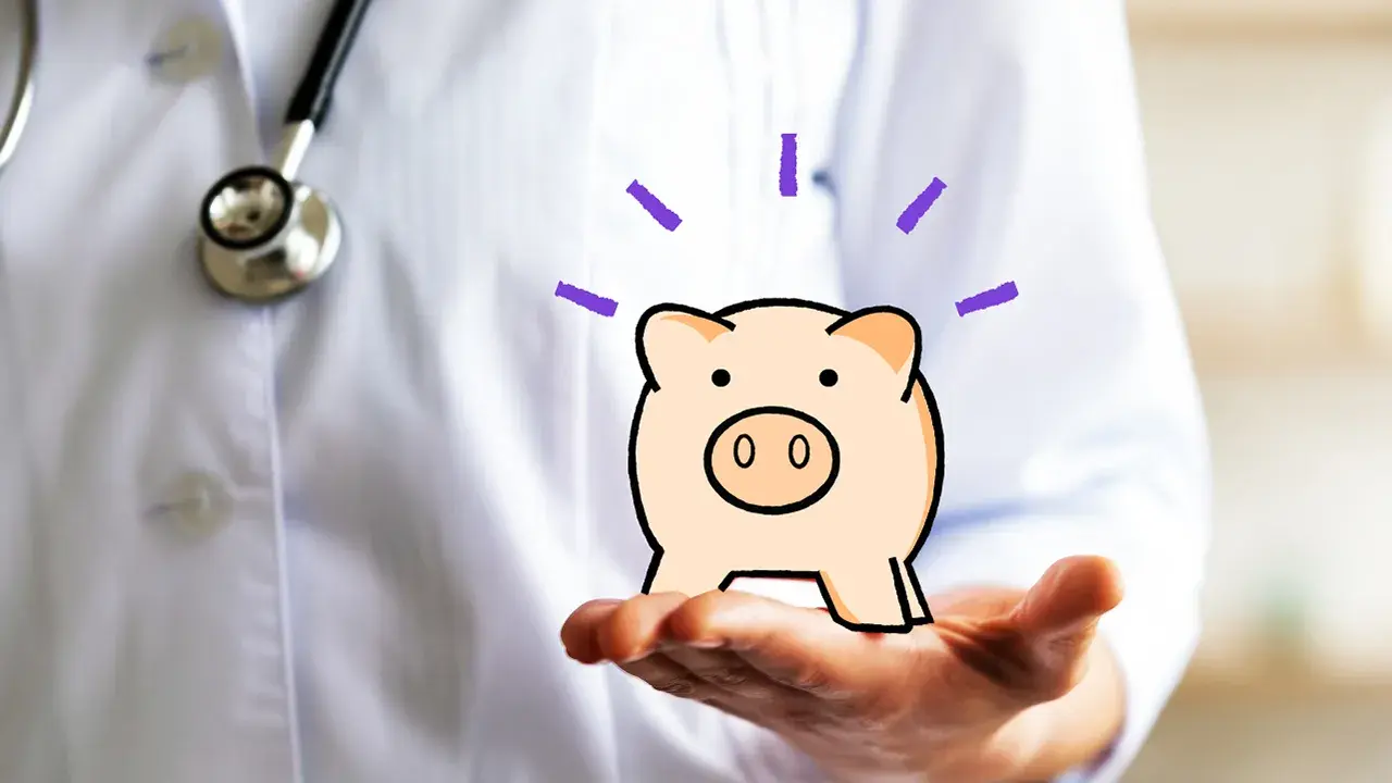 A doctor holding an illustration of a piggy bank.