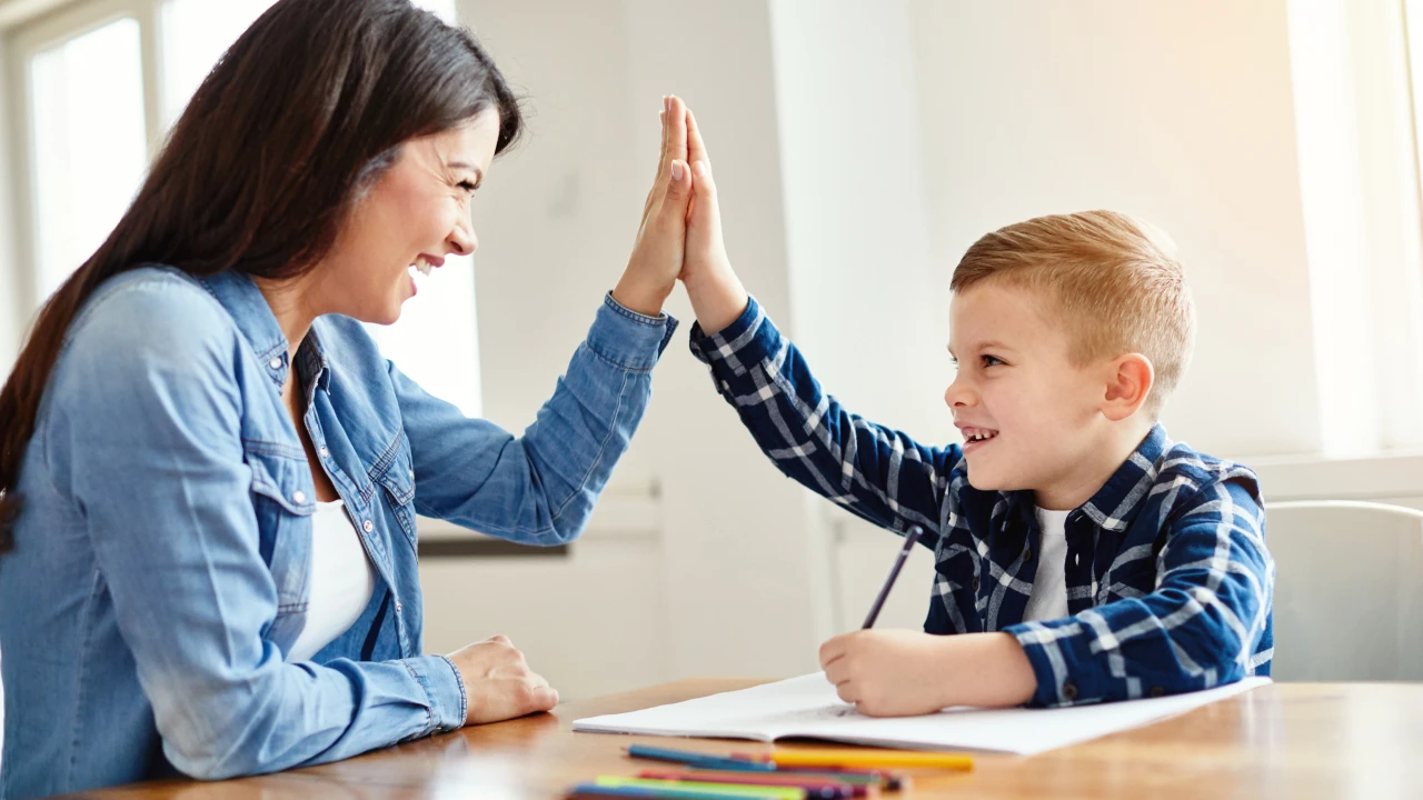Mom and son high fiving.
