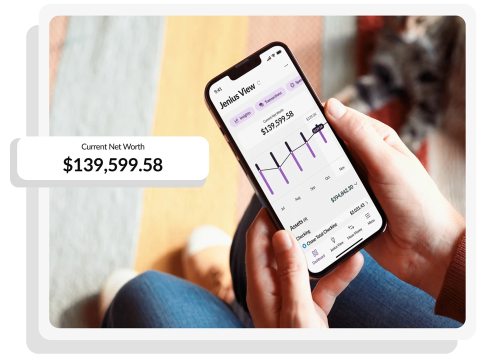 A person holding a phone viewing their net worth on the Jenius Mobile App.