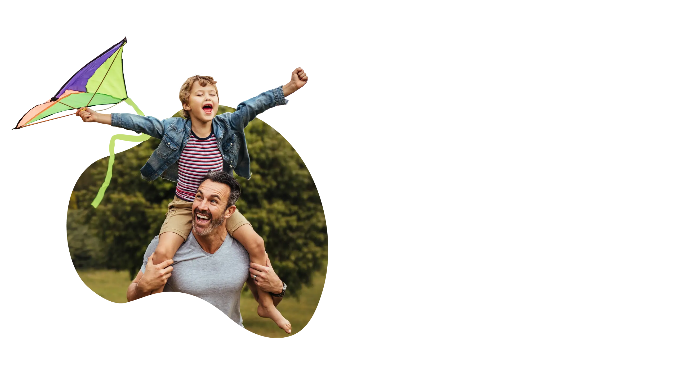Son riding on his dad's shoulder, flying a kite