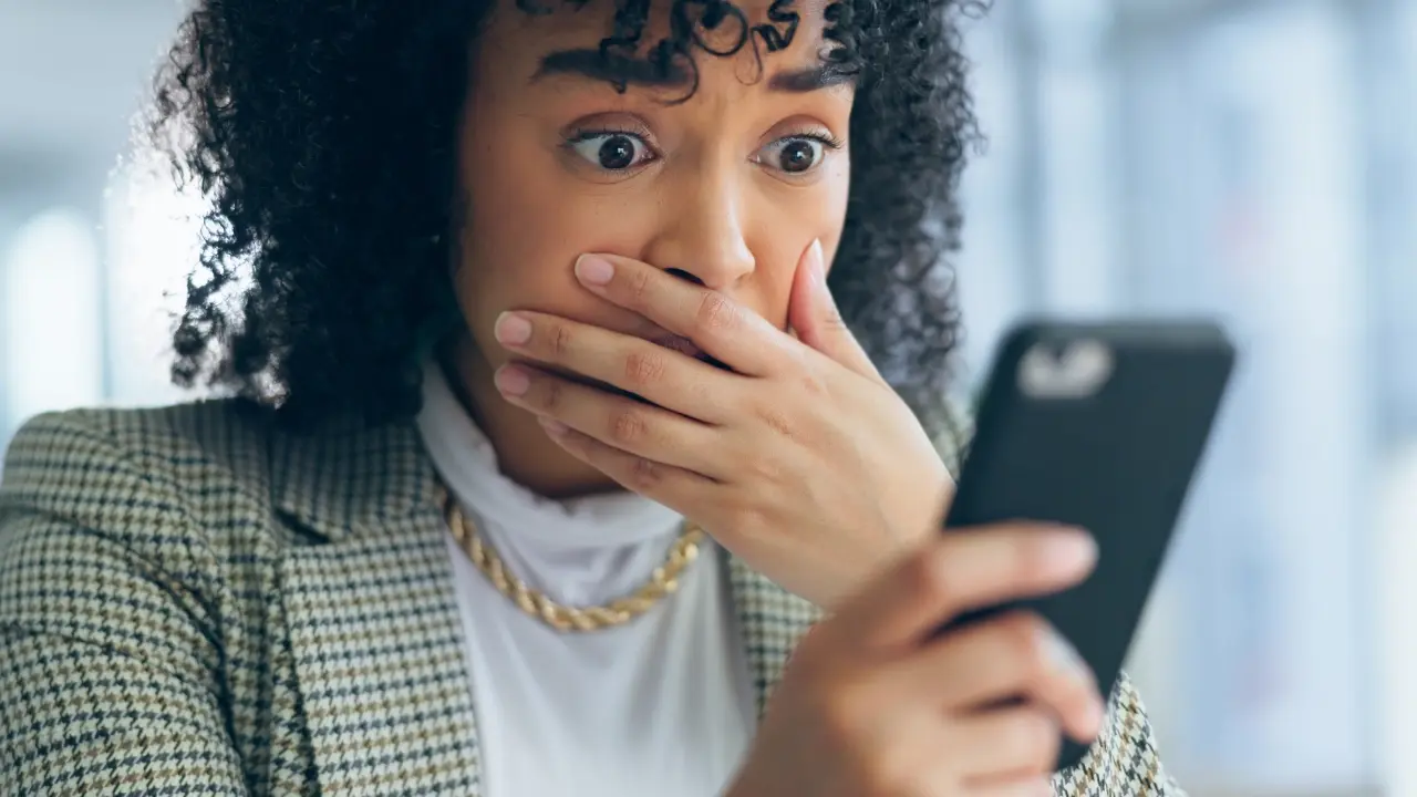 Shocked woman looking at her phone. 