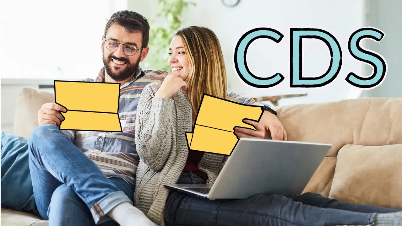 A couple sitting on a couch discussing CD options. 