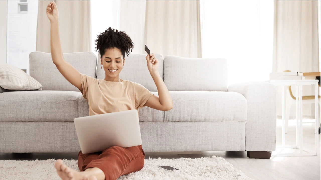 A woman sitting on the ground with a laptop. 