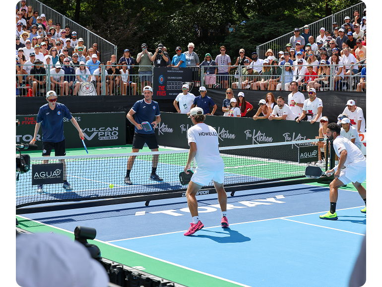 Men’s doubles pickleball player serves to the opposing team. 