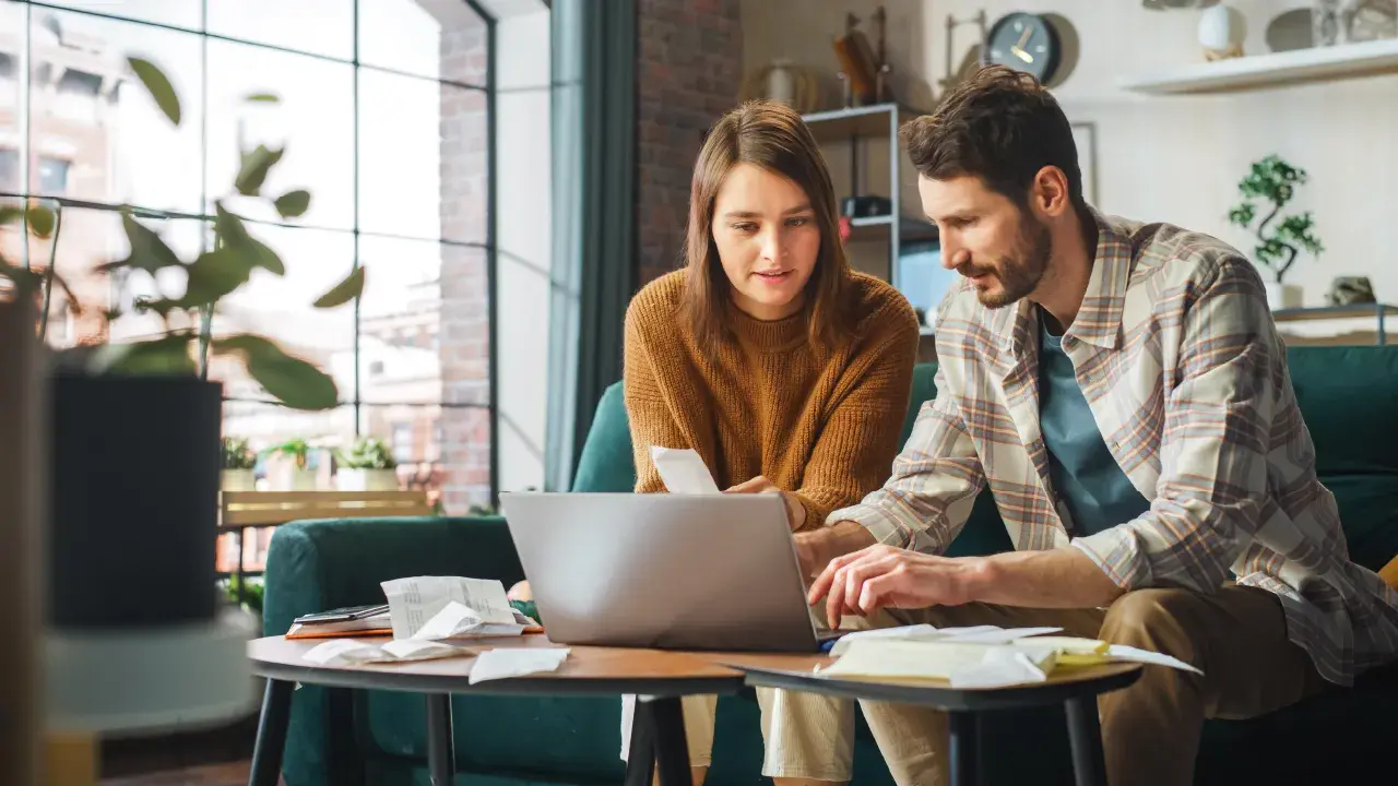 A couple looking at a computer comparing bank options. 