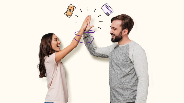 A couple cheerfully high-fiving after making a money decision. 