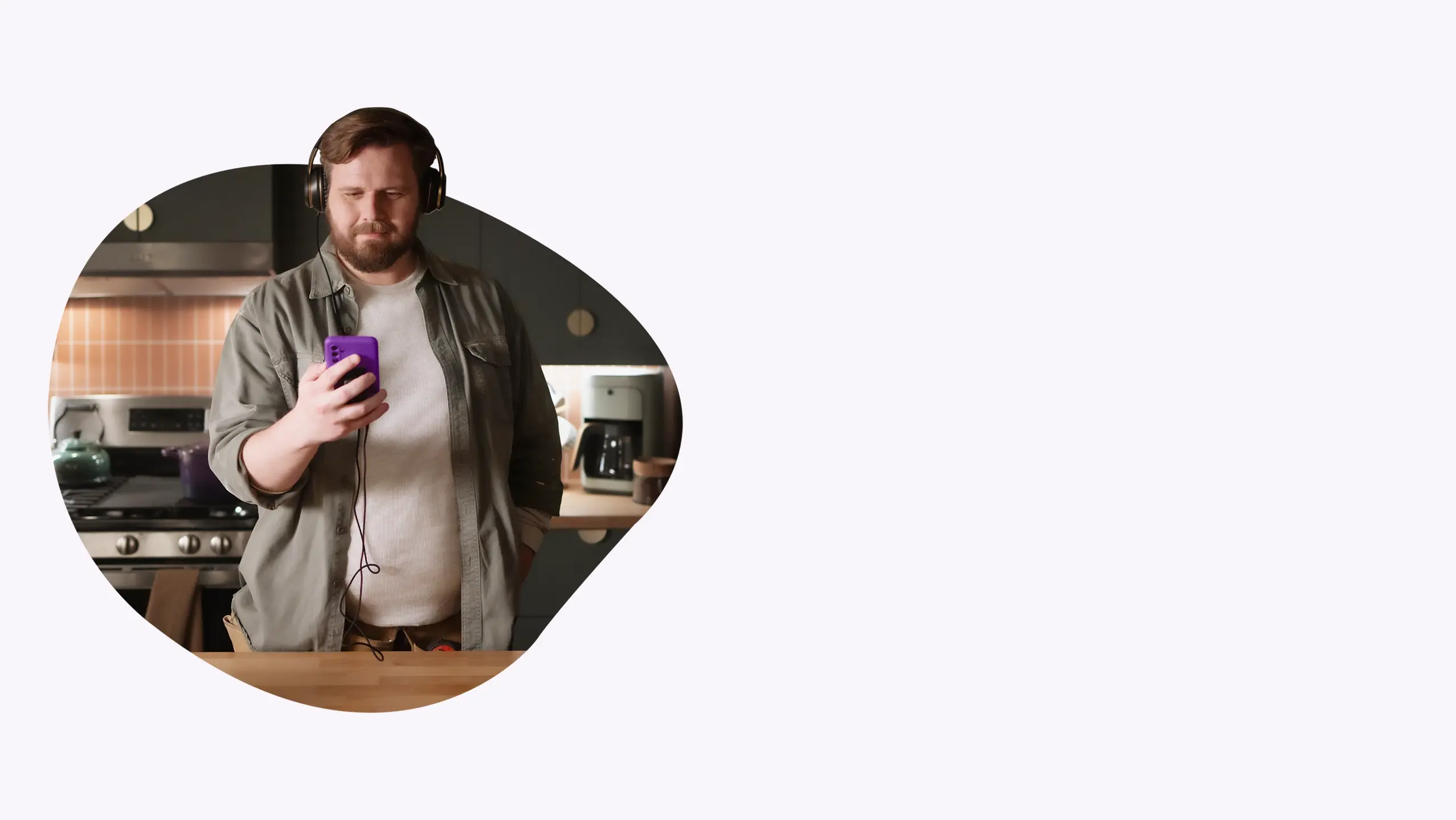 Man standing proudly in a recently renovated kitchen.
