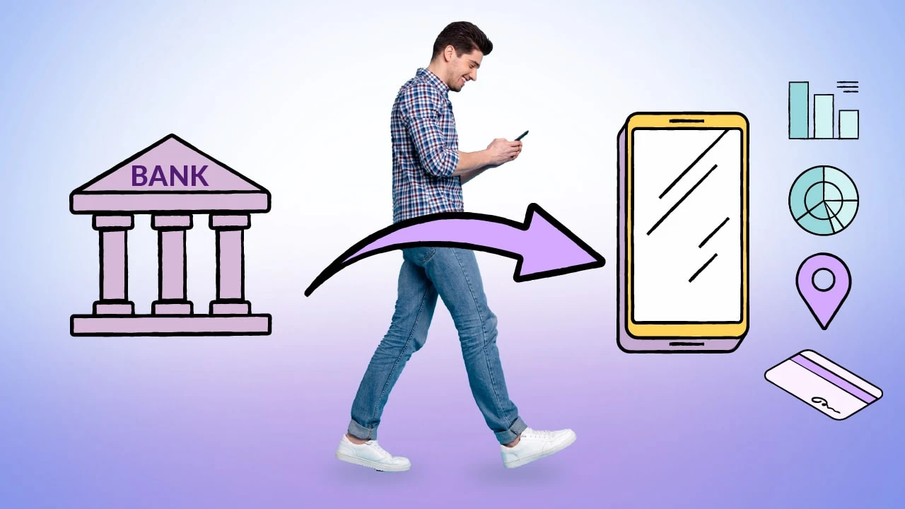 Man walking past a bank and managing finances on his cell phone.