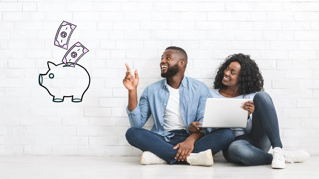 A couple sitting on the ground discussing their finances. 