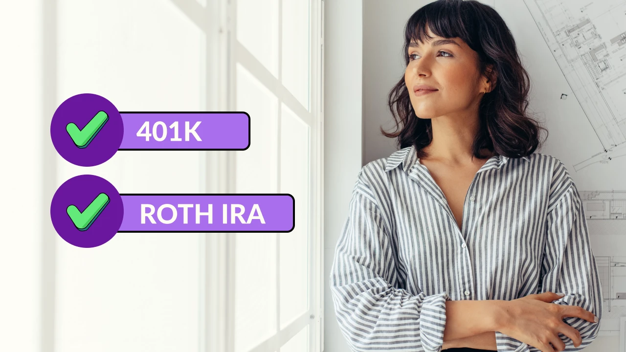 A woman stands and looks out a window.  