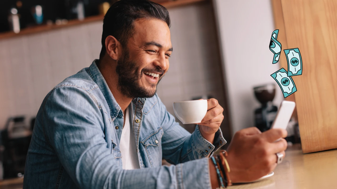 Man smiling at his cell phone. 