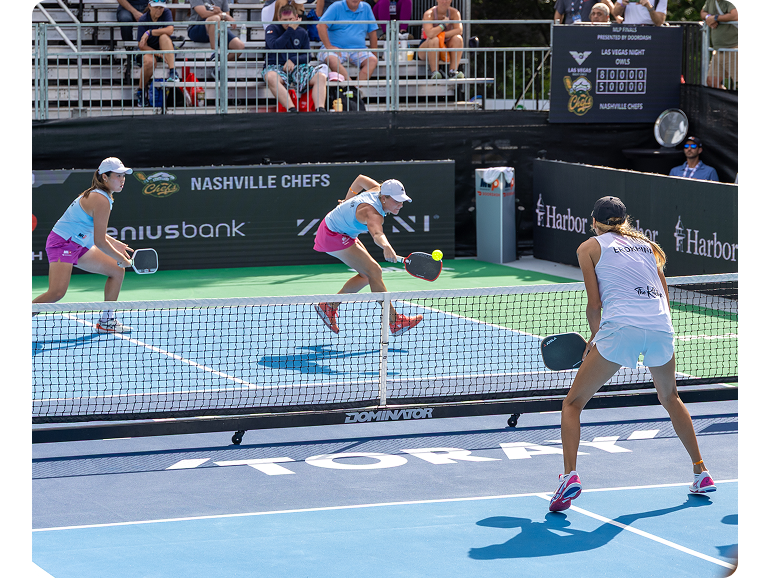 An exciting rally during a women’s double pickleball match. 