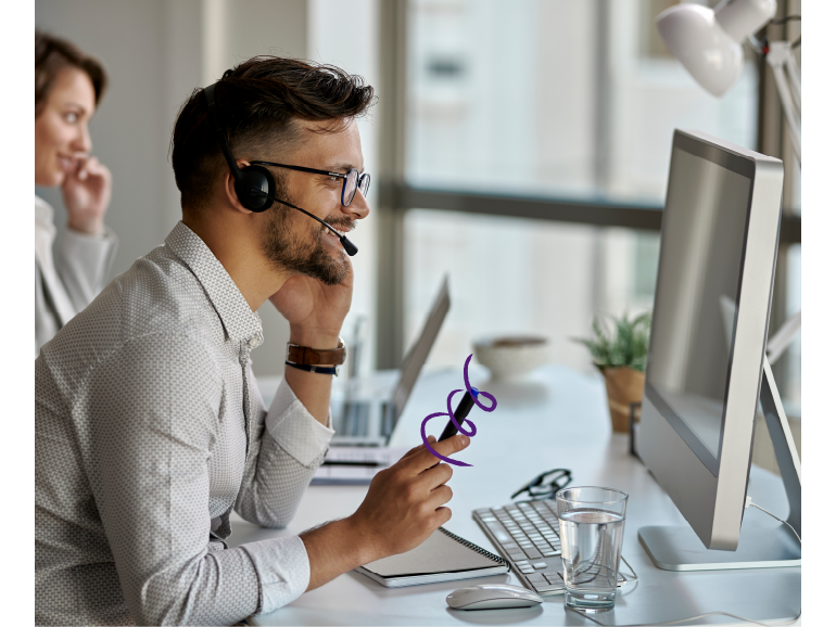 Customer service representative talking to a client using a headset.